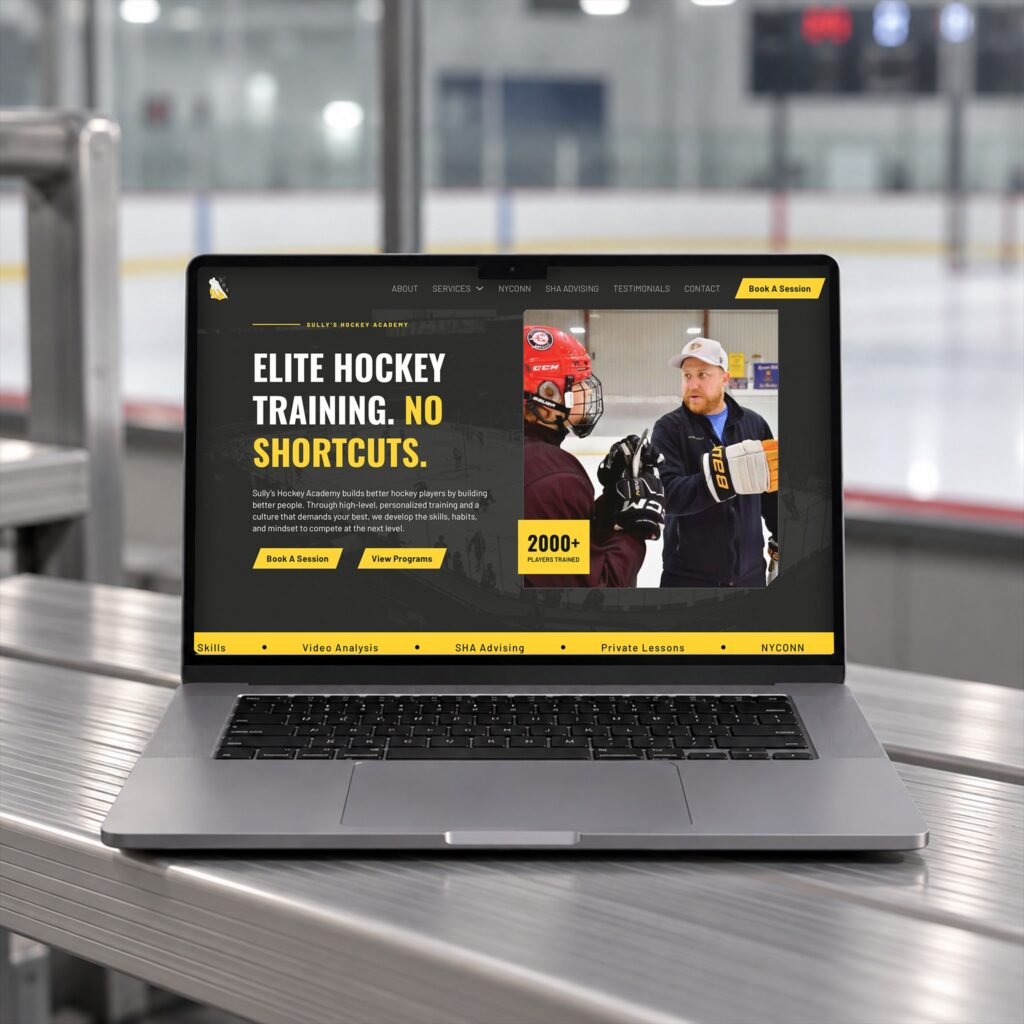 Laptop mockup of the Sully's Hockey Academy website homepage at an ice rink, designed by Posted Social